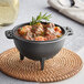 A Valor pre-seasoned cast iron bowl filled with stew on a table.