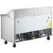 An Avantco stainless steel refrigerated sandwich/salad prep table with wheels.