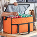 A man putting a can into a large orange Choice insulated cooler bag.