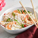 A bowl of noodles with shrimp and vegetables served with Bob's Red Mill Gluten-Free Sweet White Rice Flour.