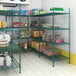 A Regency green epoxy wire shelving unit with S-Hooks holding food items.