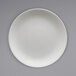 A white plate with a white circle and rim on a grey background.