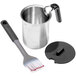An OXO stainless steel basting pot with a brush and plastic lid.