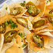 A plate of nachos with Goya whole pickled jalapeno slices.