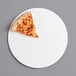 A slice of pizza on a 14" white corrugated pizza circle.
