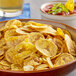 A bowl of Goya lime plantain chips with a bowl of salsa on a table.