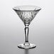 A close-up of an Arcoroc martini glass with a design on it.