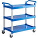 A blue utility cart with three shelves and silver legs.