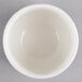 A Homer Laughlin Ameriwhite china bowl on a gray surface.