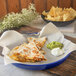 A Carlisle cobalt blue melamine serving tray with quesadillas, guacamole, and chips.