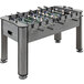 A Triumph Medford foosball table with small figures on it.