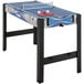 A Triumph 13-in-1 Combo Game Table with ping pong paddles and balls.