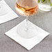 A glass of wine on a Hoffmaster Linen-Like white beverage napkin.