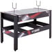 A black and red Triumph 4-in-1 game table with metal legs.