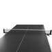A black table tennis table with a Stiga Clipper ping pong net.