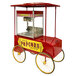 A red and yellow Paragon popcorn cart with a canopy and wheels.
