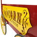 A red and yellow Paragon popcorn cart with a "Fresh" sign and canopy.