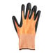 A close-up of an orange and black Mercer Culinary Millennia food processing glove with a black and orange palm.