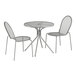 A Lancaster Table & Seating round outdoor table and 2 chairs with modern legs on an outdoor patio.