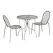 A Lancaster Table & Seating Harbor Gray round outdoor table with ornate legs and two chairs.