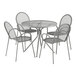 A Lancaster Table & Seating Harbor Gray round metal table with four chairs.