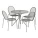 A Lancaster Table & Seating Harbor Gray round metal table with 4 chairs on a white background.