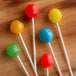 A group of lollipop sticks with six different colored lollipops.