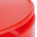 A close-up of a red HS Inc. polypropylene tortilla server with a lid.