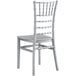 A close up of a silver resin chiavari chair with a wooden seat.