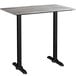A grey rectangular bar height table with a black metal base.
