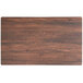 A rectangular wood table top with a textured walnut finish.
