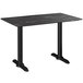 A black Lancaster Table & Seating rectangular dining table with black legs.