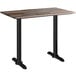 A Lancaster Table & Seating rectangular counter height table with a textured mixed plank top and two black end bases.
