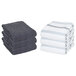 A stack of folded Monarch Brands gray stripe pattern kitchen towels.