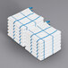 A stack of white towels with blue windowpane pattern lines.