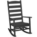 A black POLYWOOD porch rocking chair with armrests.