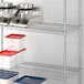 Regency chrome wire shelving unit holding containers and pots.