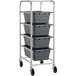 An unassembled aluminum cart with four gray bins on it.