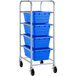 A metal Regency lug rack with four blue plastic tote boxes on it.