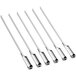 A long shot of several OXO stainless steel flat skewers with handles.