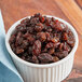 A bowl of Regal Thompson raisins on a table.