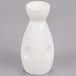 A close-up of a white porcelain Fuji Sake bottle with a handle.