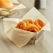 Fried onion rings in a basket lined with an EcoChoice natural kraft deli wrap.