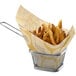 A customizable natural kraft basket liner with a basket of french fries.