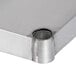An Advance Tabco solid stainless steel shelf with a hole in it.