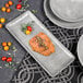 An Elite Global Solutions rectangular cement melamine plate with food on it.