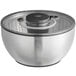An OXO stainless steel salad spinner bowl with a lid.