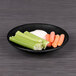 A plate of celery sticks and baby carrots on a black Elite Global Solutions Hermosa melamine plate.