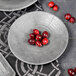 A set of Elite Global Solutions cement embossed coupe melamine plates with cranberries on them.