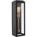 A Kalco Ashland outdoor wall sconce with a black and gold finish and clear glass over the light bulb.